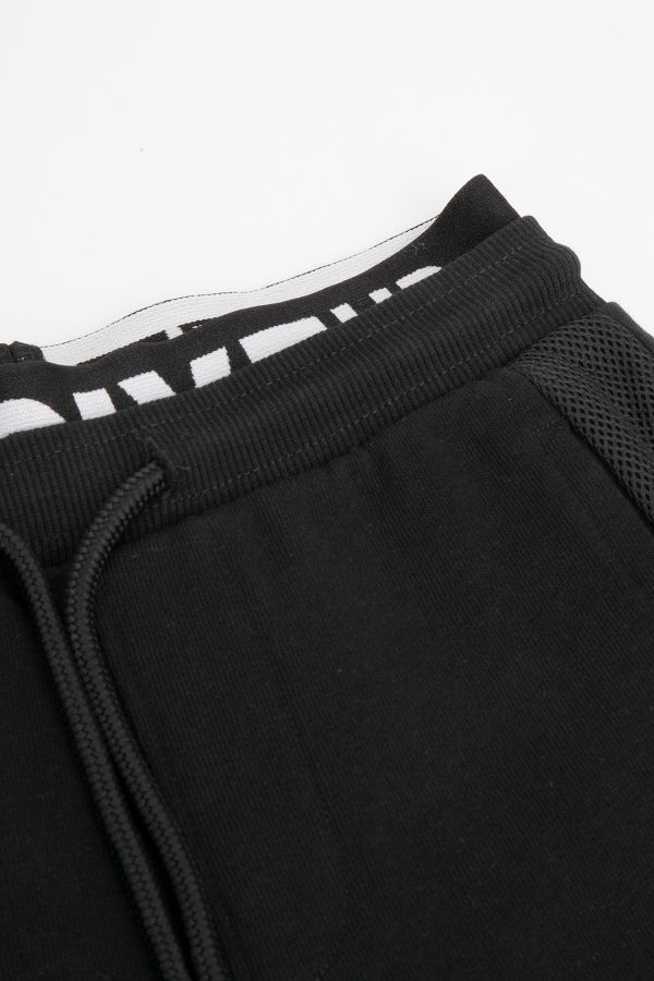 Spodnie dresowe czarne z ozdobną gumą w pasie o fasonie SLIM 2218341